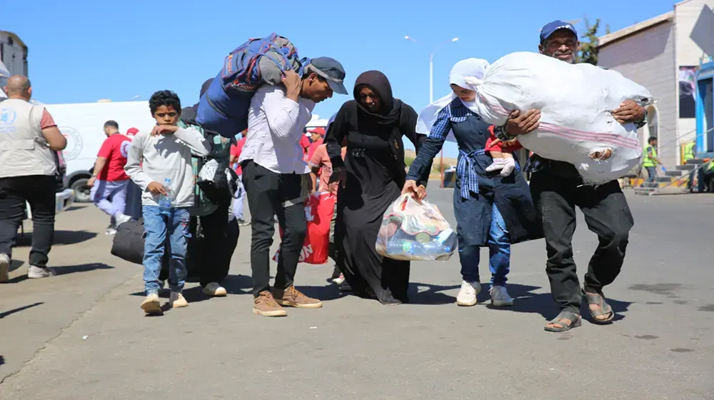 "Families cross the Lebanese-Syrian border at Jdeidet Yabous, seeking safety and hope amid challenging circumstances."